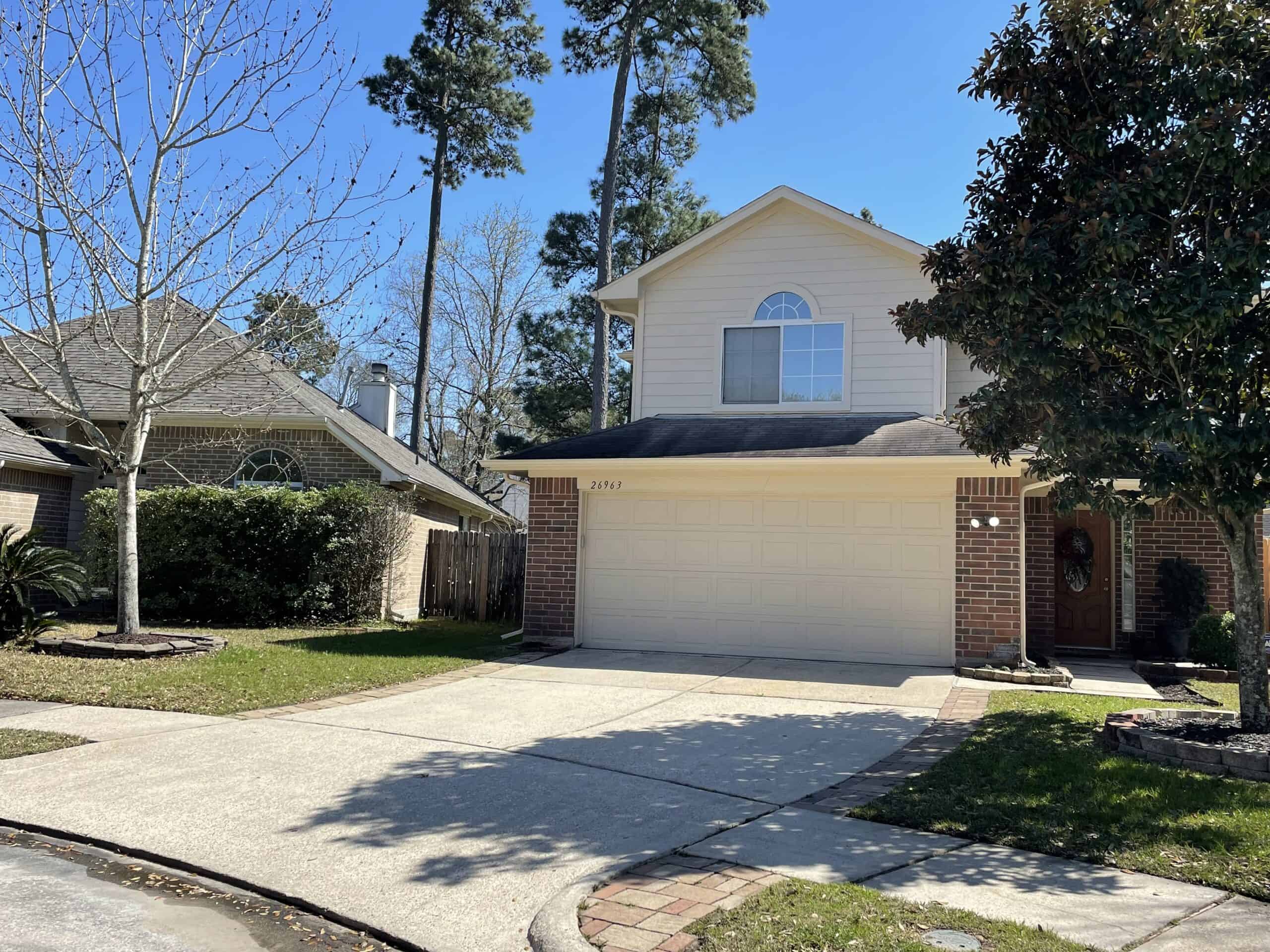 Pressure-washed home with a clean landscape in Huffman
