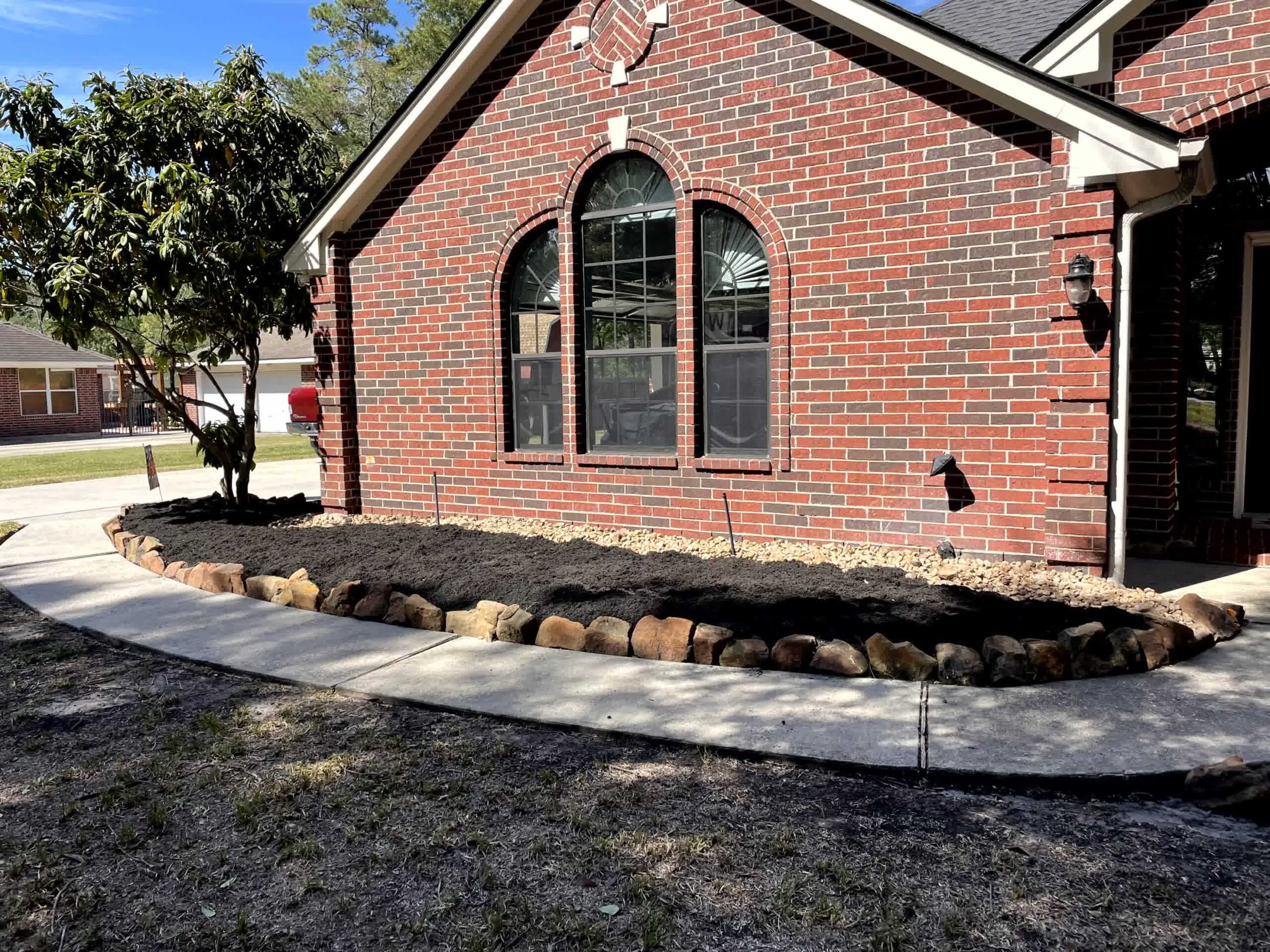 cut n edge property management spring Top Landscaping Projects to Prevent Weed Growth Effectively scaled -Cut'N Edge Property Management Laying down mulch like this can help prevent weeds.