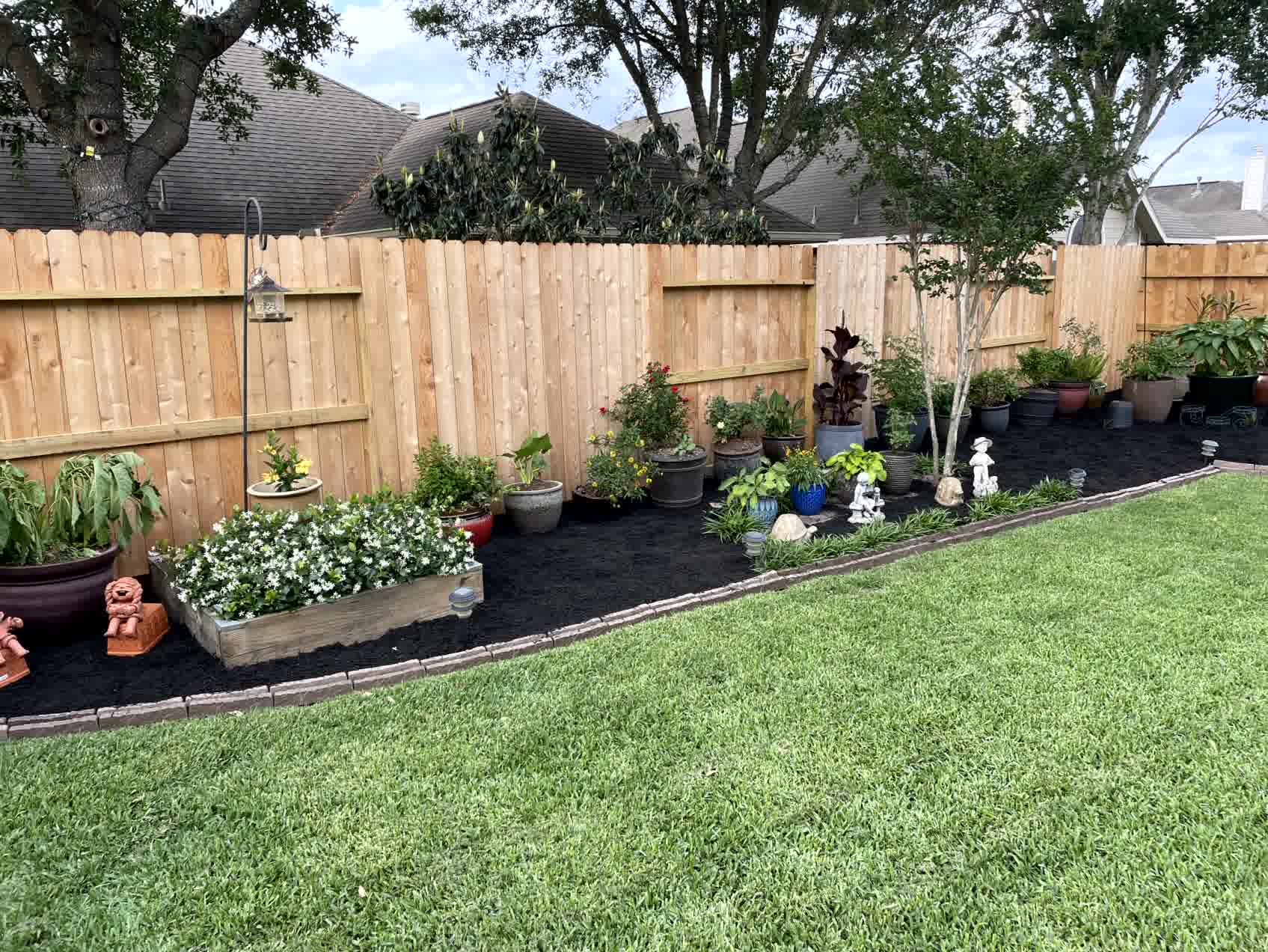 A gorgeous fence with new plants and fresh mulch as well.

